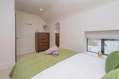 a bedroom with a large bed and a window at Tackroom Great Ness Shrewsbury in Great Ness