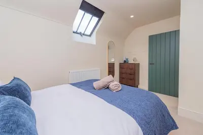 a bedroom with a bed with a towel on it at Tackroom Great Ness Shrewsbury in Great Ness