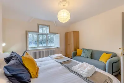 a bedroom with a large bed and a couch at 5 Bed in Church Stretton oc-t30413 in Church Stretton