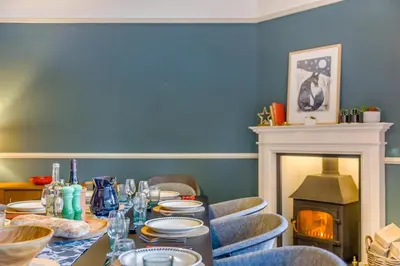 a dining room with a table and a fireplace at 5 Bed in Church Stretton oc-t30413 in Church Stretton