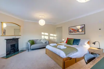 a bedroom with a bed and a couch and a fireplace at 5 Bed in Church Stretton oc-t30413 in Church Stretton