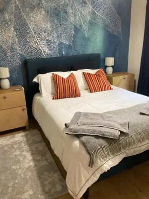 a bed with white sheets and pillows in a bedroom at Broughshane in Church Stretton