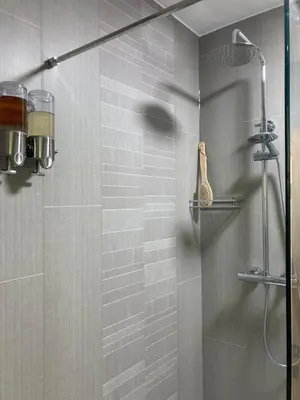a bathroom with a shower with a glass door at Broughshane in Church Stretton