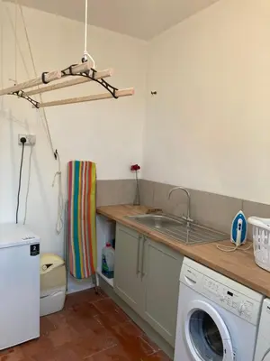 a kitchen with a washing machine and a sink at Broughshane in Church Stretton
