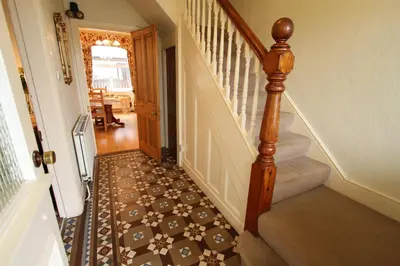 a hallway with a stairway with a staircase at Below the castle at Snowdonia in Harlech
