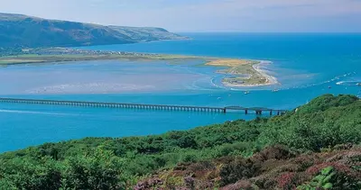 a bridge over a large body of water at Below the castle at Snowdonia in Harlech