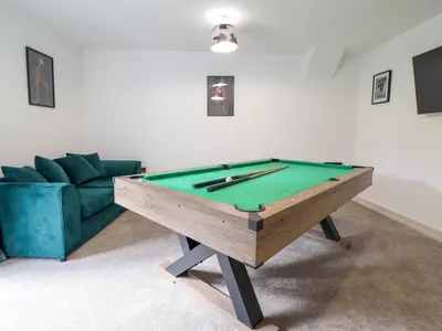 a living room with a pool table and a couch at Threshers Barn in Oswestry