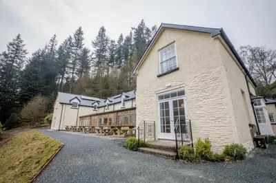 a large white building with a lot of windows at Ty Penbont House in Rhayader