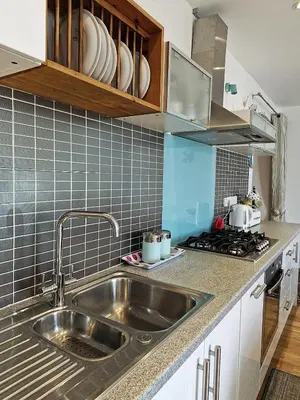 a kitchen with a sink and a stove at Green Hill ground floor Family Apartment in Barmouth