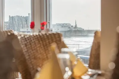 a group of chairs sitting in front of a window at No 46 Marine Terrace in Aberystwyth