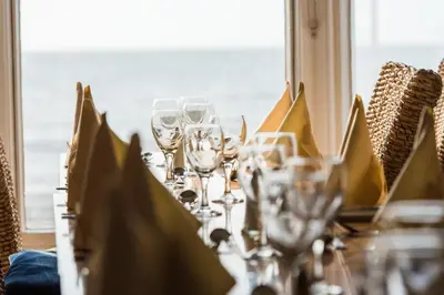 a table with wine glasses on top of it at No 46 Marine Terrace in Aberystwyth