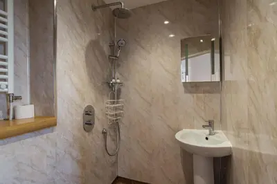 a bathroom with a shower and a sink at No 46 Marine Terrace in Aberystwyth