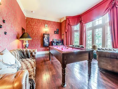 a living room with a pool table in it at Gwynfryn in Llanarth