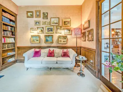 a living room with a white couch with pillows on it at Gwynfryn in Llanarth