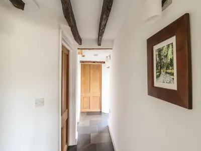 a hallway with white walls and a picture on the wall at Clywedog Cottage in Dolgellau