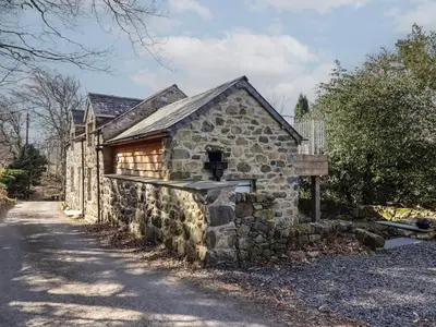 a stone building with a window on the side of it at Clywedog Cottage in Dolgellau