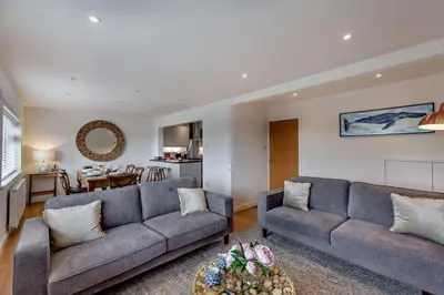 a living room with two couches and a kitchen at 3 Bed in Aberdovey oc-n29124 in Aberdyfi