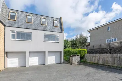 a large white house with two garage doors at 3 Bed in Aberdovey oc-n29124 in Aberdyfi