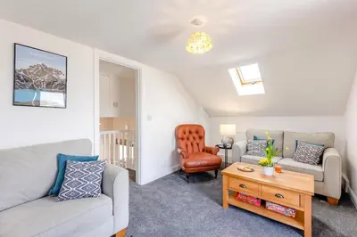 a living room with a couch and a chair at 2 Bed in Rhoslefain oc-i30763 in Llangelynin