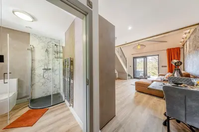 a bathroom with a shower and a bed in a room at 1 Bed in Berriew oc-a31113 in Berriew