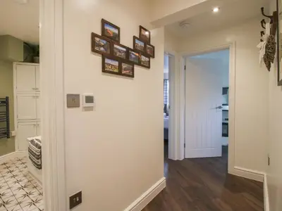 a hallway of a home with pictures on the wall at Blockley Lodge in Church Stretton
