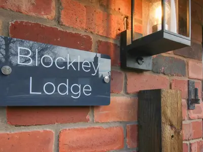a sign on the side of a brick wall at Blockley Lodge in Church Stretton