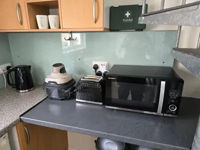 a microwave sitting on a counter in a kitchen at The Loft at Box Bridge in Brecon