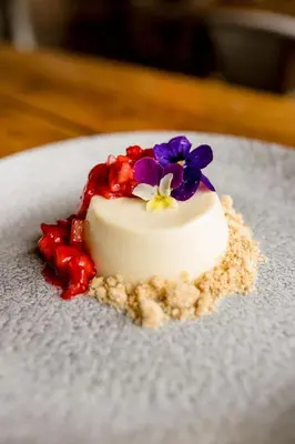 a small white cake with flowers on top on a plate at Sweeney Hall Hotel in Oswestry