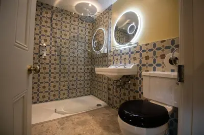 a bathroom with a toilet and a sink and a mirror at Y Castell in Llangadog