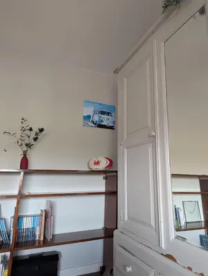 a room with a book shelf and a door at Number 46 in Bicton