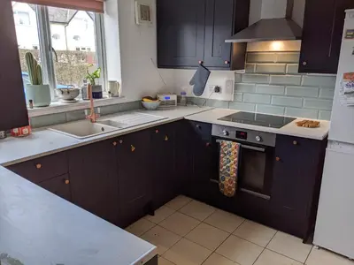 a kitchen with a sink and a stove top oven at Number 46 in Bicton