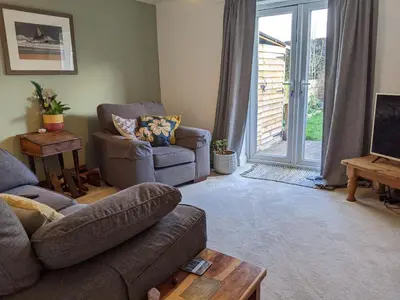 a living room with a couch and a chair at Number 46 in Bicton
