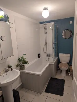 a bathroom with a tub and a sink and a toilet at Number 46 in Bicton