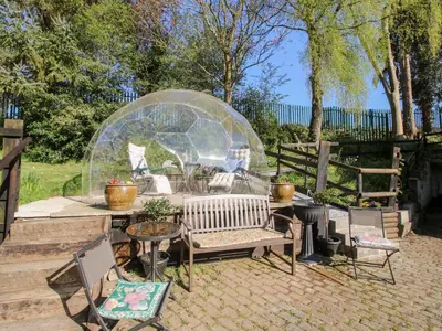 a garden with a glass igloo and a table and chairs at The Millers Roost at Dudgeley Mill in Church Stretton