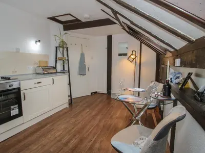 a kitchen and dining room with a glass table at The Millers Roost at Dudgeley Mill in Church Stretton