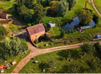 an aerial view of a farm with a barn and a lake at The Sitting Duck in Greet