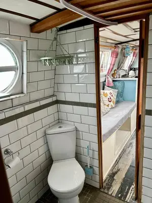 a bathroom with a toilet in a trailer at The Sitting Duck in Greet