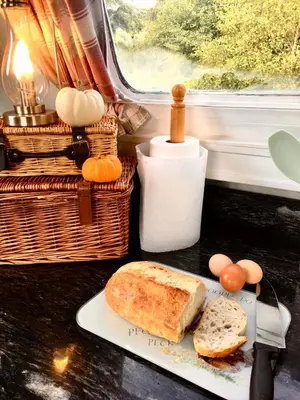 a table with a plate of bread and eggs and a basket at The Sitting Duck in Greet