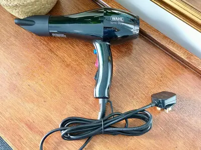 a hair dryer with a cord on a table at The Loft - Shrewsbury in Shrewsbury
