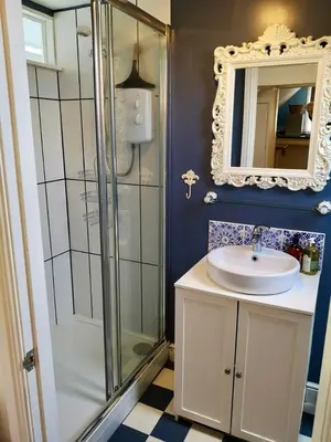 a bathroom with a shower and a sink and a mirror at The Loft - Shrewsbury in Shrewsbury