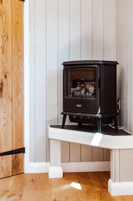 a stove sitting on a table in a room at Shepherd's Hut at Lythwood, Near Shrewsbury in Baystonhill