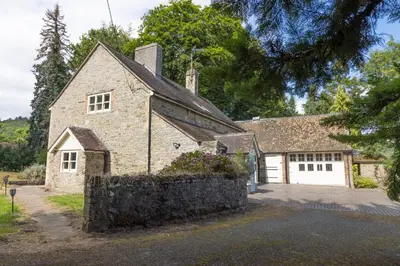 a large stone house with a white garage at 4 bed cottage Breath-taking views Sleeps 8 in Presteigne