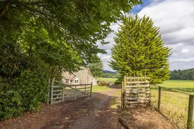 a gate to a farm house with a fence at 4 bed cottage Breath-taking views Sleeps 8 in Presteigne