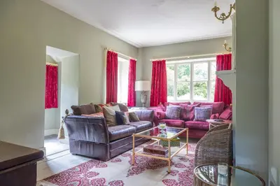 a living room with a couch and a table at 4 bed cottage Breath-taking views Sleeps 8 in Presteigne