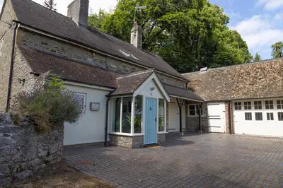 an old stone house with a blue door at 4 bed cottage Breath-taking views Sleeps 8 in Presteigne