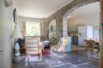 a kitchen and living room with a table and chairs at 4 bed cottage Breath-taking views Sleeps 8 in Presteigne