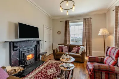 a living room with a fireplace and a tv at 5 Bed in Hundred House oc-l31090 in Hundred House