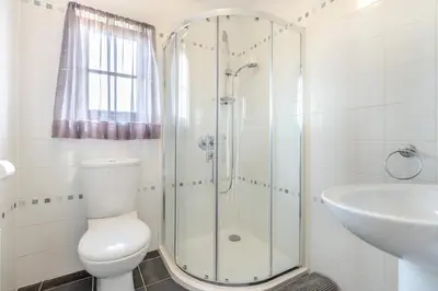 a bathroom with a shower and a toilet and a sink at 5 Bed in Ystrad Meurig oc-r31133 in Ystrad Meurig