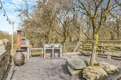 a backyard with a grill and a tree and a fence at 5 Bed in Ystrad Meurig oc-r31133 in Ystrad Meurig