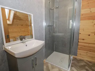 a bathroom with a sink and a shower at Sunset Lodge 5 in Llanbedr